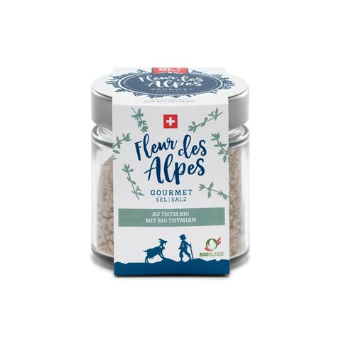 Glas mit "Fleur des Alpes" Gourmet-Salz mit Bio-Thymian. Das Etikett zeigt die Schweizer Flagge, die Aufschrift BIOSUISSE und eine Illustration von einer Ziege und einem Hirten.