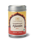 Eine silberne Metalldose „Ajwain – Königskümmel“ (ganz) von Classic Ayurveda mit einem gelb-roten Etikett und einem Bio-Siegel.