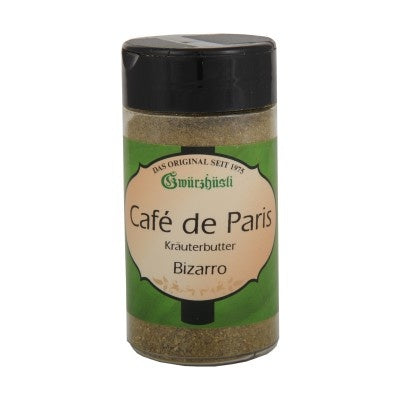 Ein transparentes Gewürzglas mit schwarzem Deckel, gefüllt mit „Café de Paris Bizarro“ Kräuterbutter-Gewürzmischung von Gwürzhüsli, mit einem grün-cremefarbenen Etikett.