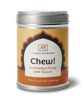 Eine silberne Metalldose „Chew! Samenmischung zum Kauen“ von Classic Ayurveda mit einem gelb-orangefarbenen Etikett und einem bogenförmigen Design.