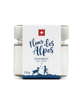 Ein kleines Glas mit 130g „Fleur des Alpes“ Gourmet-Salz, versehen mit einem weißen Etikett mit Schweizer Flagge und einer blauen Illustration einer Person mit einer Bergziege.
