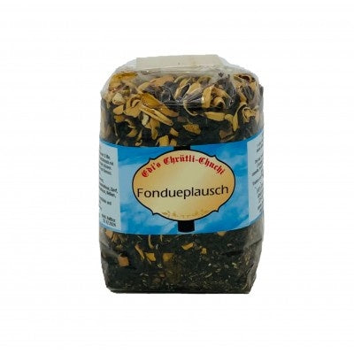 Ein transparenter Beutel mit einer losen, dunkelgrünen und beigefarbenen Teemischung, auf dessen Etikett "Edi's Chrüütli-Chuchi Fondueplausch" steht.