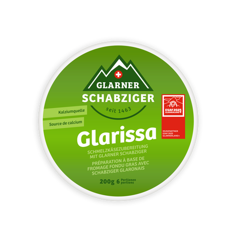 Rundes Etikett des Schmelzkäse-Produkts "Glarissa" von Glarner Schabziger, beworben als Kalziumquelle. Es zeigt ein Logo der Schweizer Berge und das ESAF 2025 Munipartner-Logo.