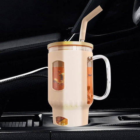 Ein beige-farbener Glasbecher, gefüllt mit einem kohlensäurehaltigen Getränk, steht in einem Getränkehalter im Auto mit dunklen Leder- oder Kunststoffsitzen im Hintergrund.