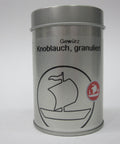 Eine silberne Metalldose für „Knoblauch, granuliert“ von Landolt Hauser AG, mit einer schwarzen Segelschiff-Illustration und einem roten Logo auf weißem Hintergrund.