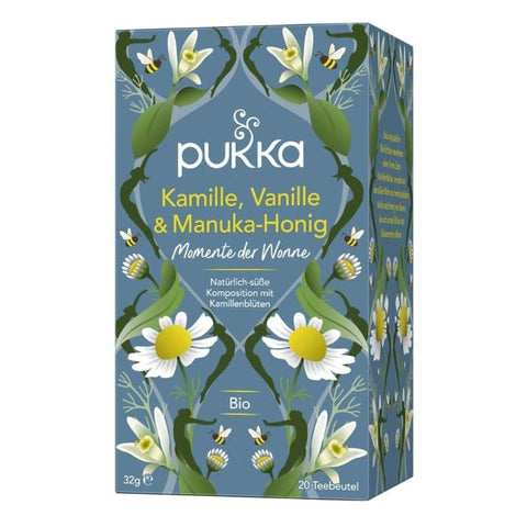 Pukka Teepackung, blau, mit Kamille, Vanille und Manuka-Honig, verziert mit Blüten und Bienen.