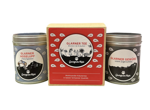 Ein Set aus drei Produkten, bestehend aus einer Teeschachtel und zwei Gewürzdosen mit der Aufschrift „Glarner“.