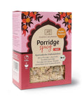 Eine Packung „Porridge Spicy“ von Classic Ayurveda, gekennzeichnet als vegan und Bio-zertifiziert, mit einem dekorativen rosa-orangen Design und einem Sichtfenster, das die trockene Hafer-Gewürz-Mischung zeigt