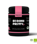 Eine schwarze Dose Urban Tea Factory mit rosa Band, beschriftet mit "So Damn Pretty" und der Produktbezeichnung "Grünteemischung mit Guarana & Rosenblüten". Auf der Dose sind auch das BIO-Siegel und die Kontrollnummer abgebildet.