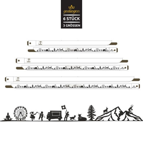 Sechs weiße Tütenhüter in drei verschiedenen Größen mit durchgängigem schwarzem Scherenschnitt-Muster mit Schweizer Motiven (Kuh, Berge, Lastwagen).