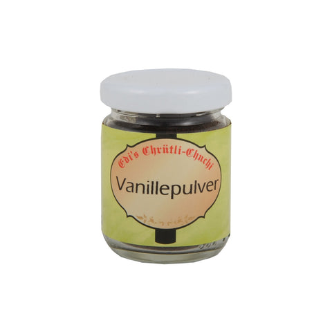 Ein kleines Glas „Vanillepulver“ von Edi's Chritli-Chuchi mit einem hellgrünen Etikett, rot-schwarzer Schrift im gotischen Stil und einem weißen Schraubdeckel.