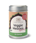 Eine silberne Gewürzdose für „Classic Ayurveda Veggie Heaven Gewürz“ mit einem grün-pfirsichfarbenen Etikett, dekorativem Bogen, Bio-Logo und dem Untertitel „Für Gemüse“.