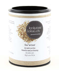 Ein zylindrischer Kartonbehälter mit der arabischen Gewürzmischung „Za'atar“ von Kräuterlokal.ch, mit einem weißen Etikett und einer kreisförmigen Abbildung der Kräuter- und Samenmischung.